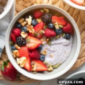 Blueberry Protein Smoothie Bowls 8 A bowl of creamy blueberry cottage cheese smoothie, garnished with pepitas and walnuts.