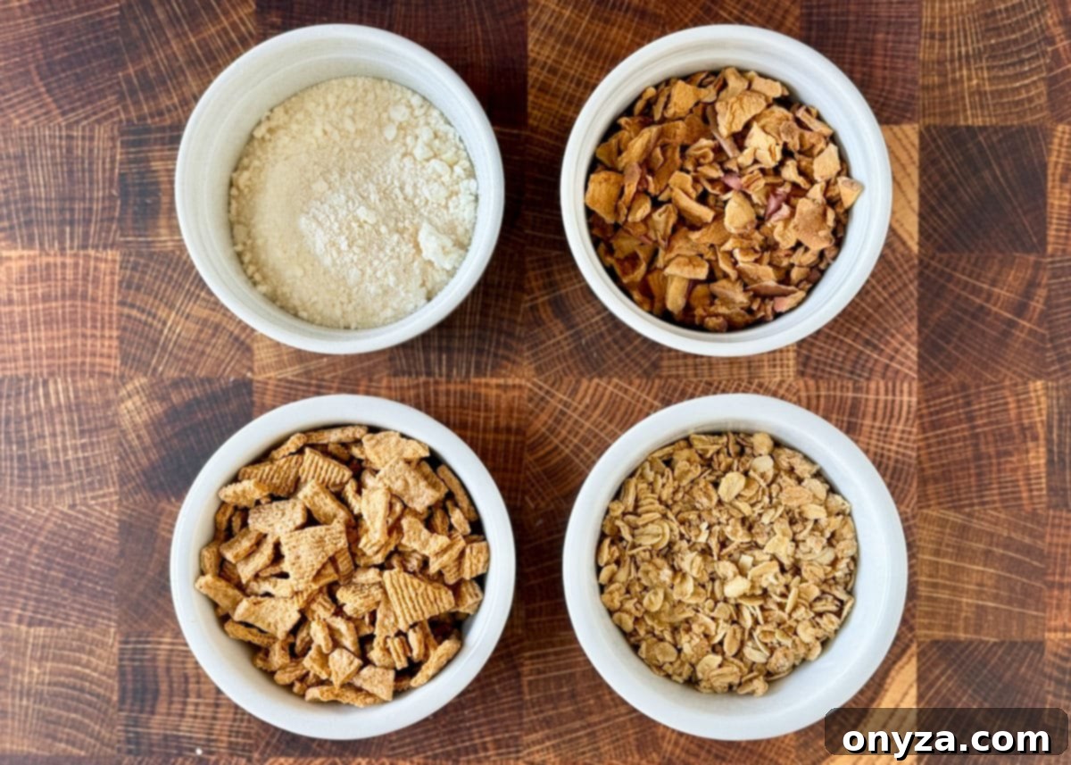 white bowls containing (clockwise from upper left): crushed dried apples, chopped apple chips, granola, chopped graham cracker cereal
