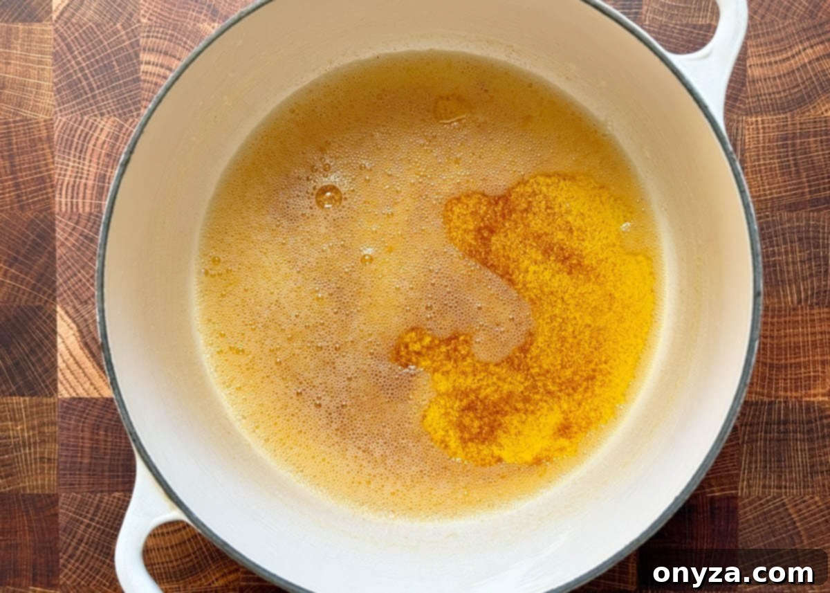 overhead of browned butter in a white enameled cast iron pot