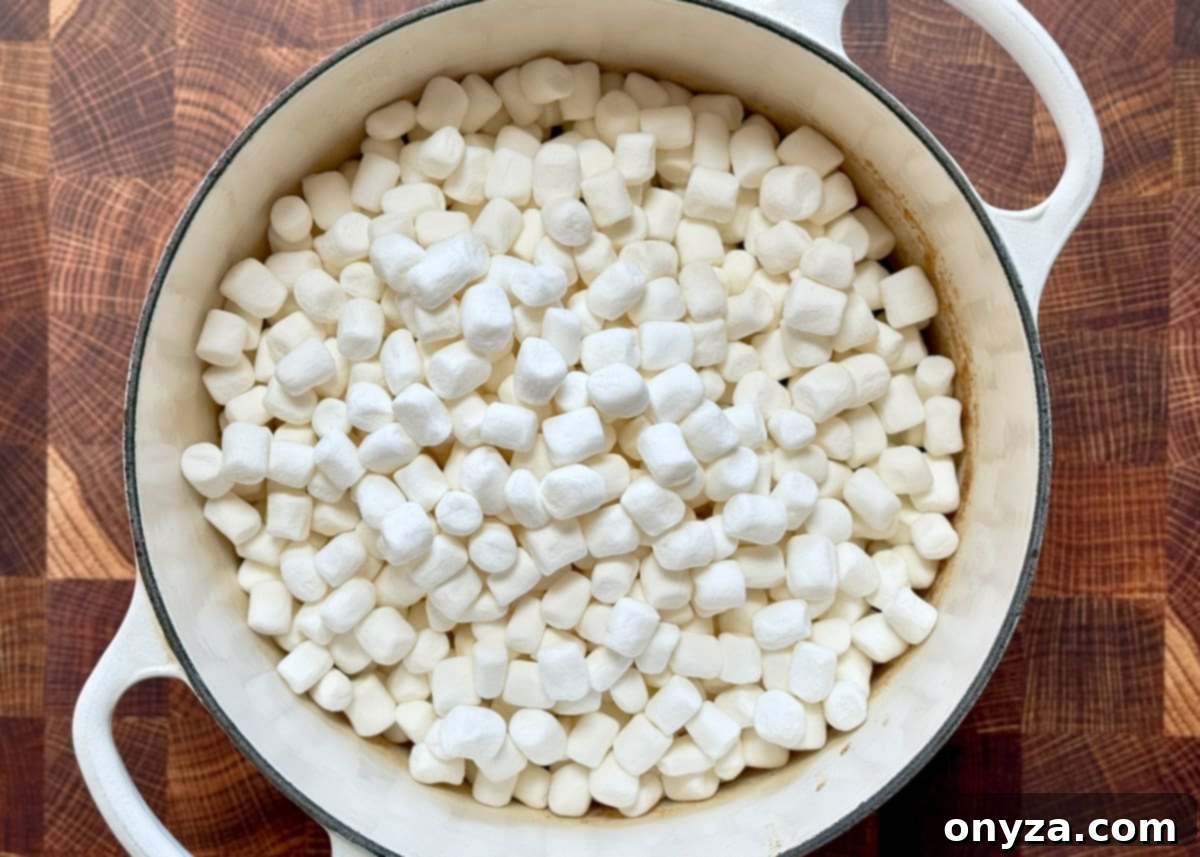 miniature marshmallows in a white enamaled cast iron pot