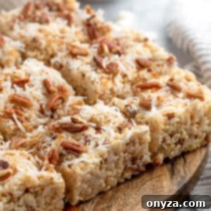 coconut pecan rice krispie treats cut into squares on a wooden serving board