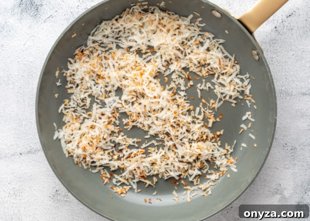 overhead of toasted coconut in a skillet