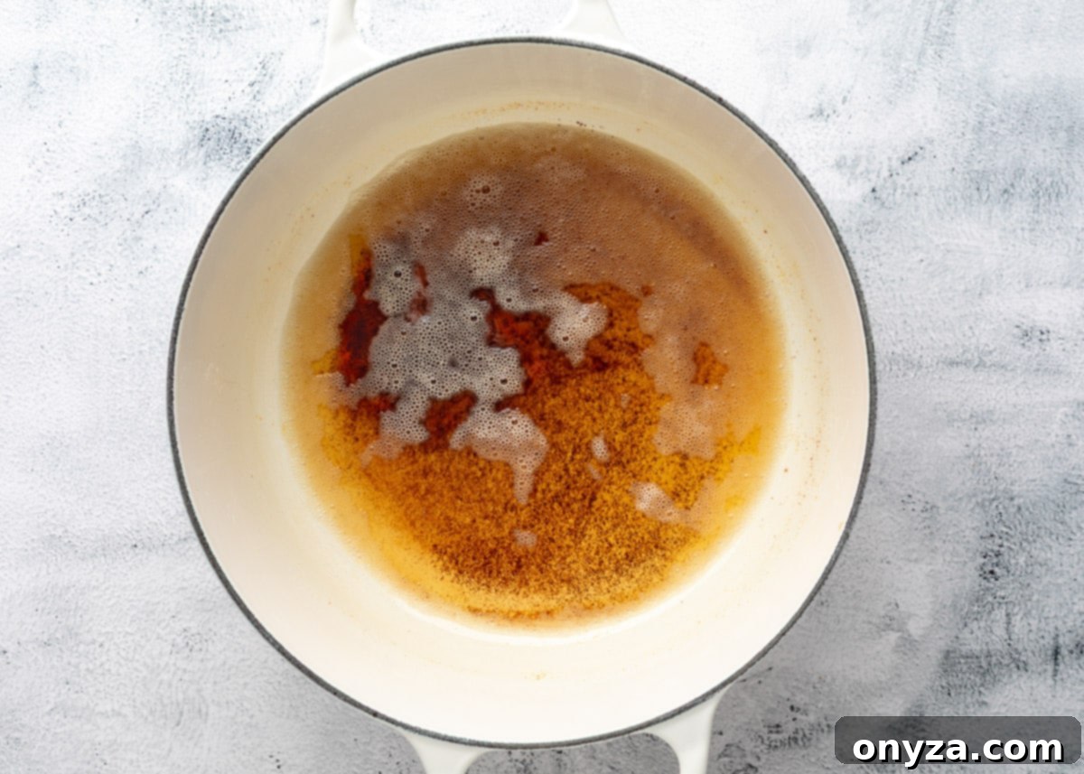 overhead of brown butter in a white enameled cast iron pot