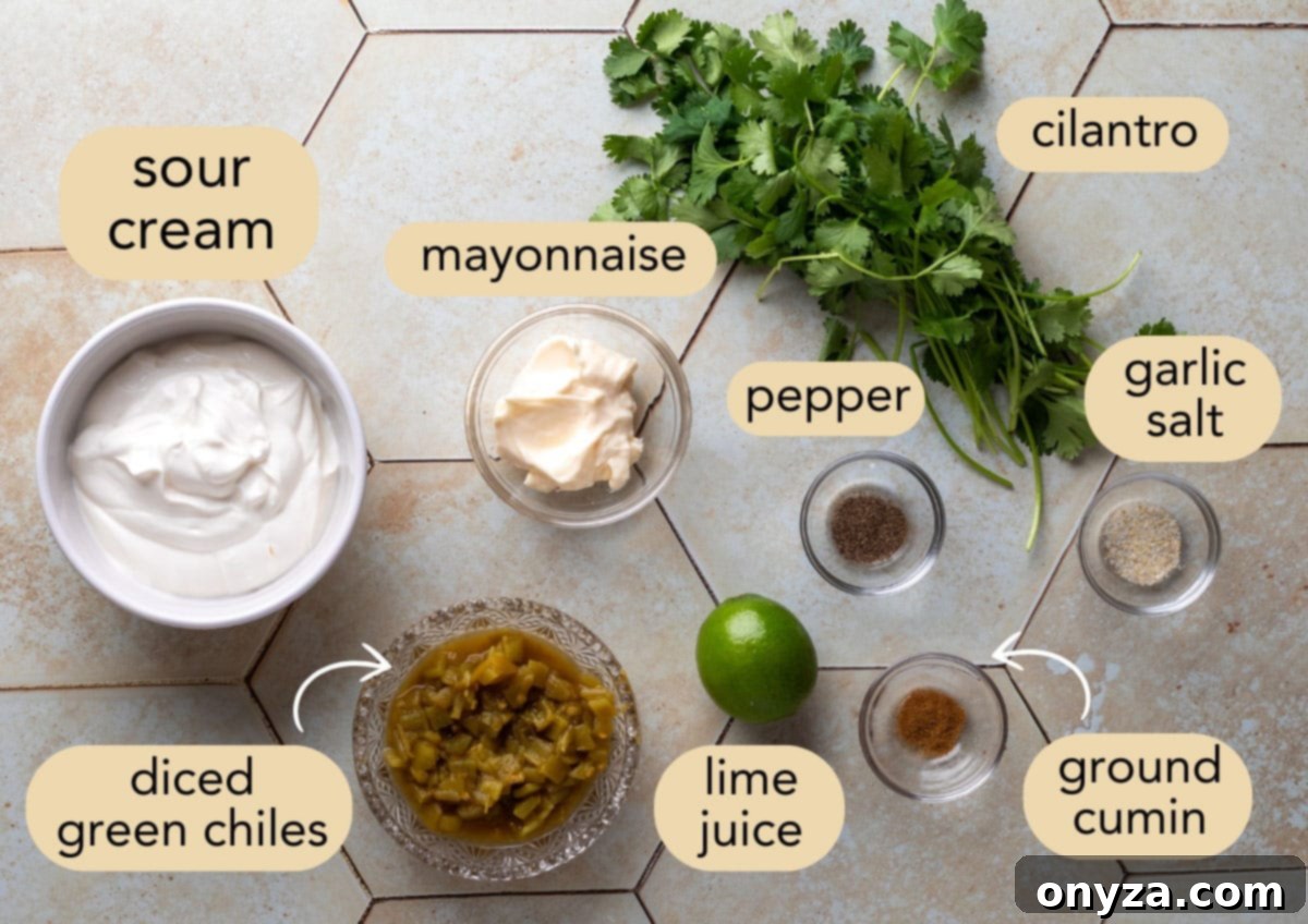 Southwestern Green Chile Cilantro Dip 3 overhead of ingredients needed to make green chile dip in bowls on an ivory tile surface