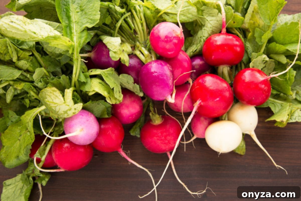easter egg radishes on a dark brown wood cutting board