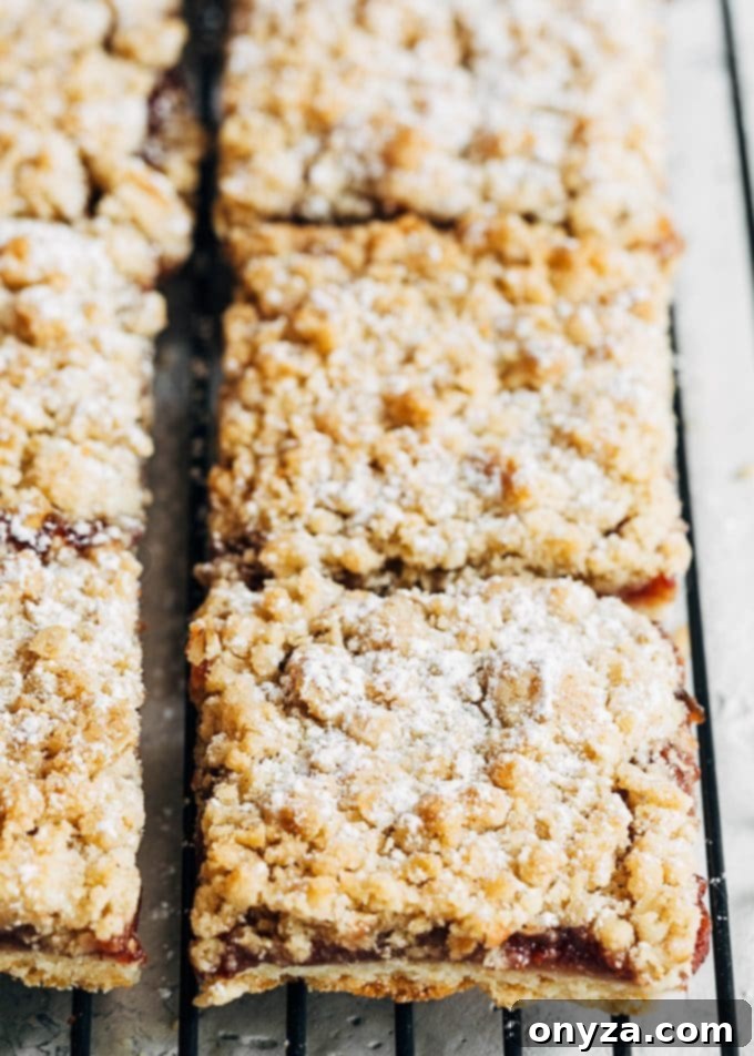 Freshly baked jam bars with crumble topping cooling on a wire rack