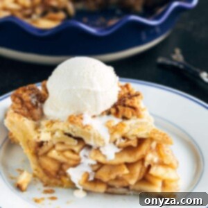slice of homemade apple pie with a scoop of vanilla ice cream