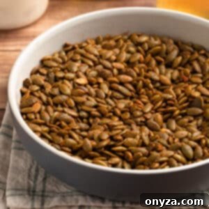 A ceramic bowl of spiced pepitas, ready for serving or snacking.