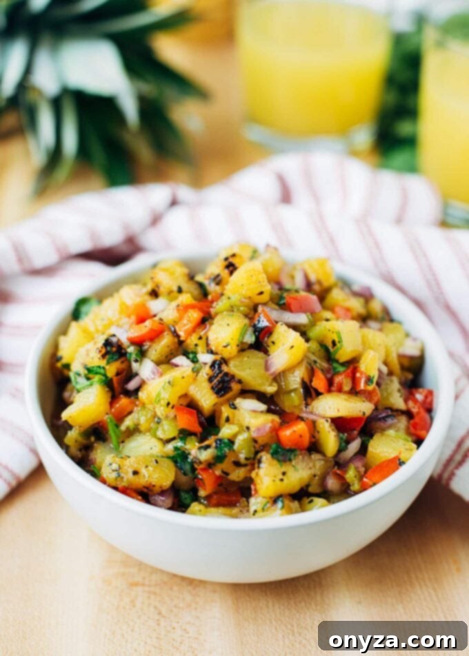 Sweet & Smoky Grilled Pineapple Salsa 2 Delicious grilled pineapple salsa recipe served in a rustic bowl with tortilla chips