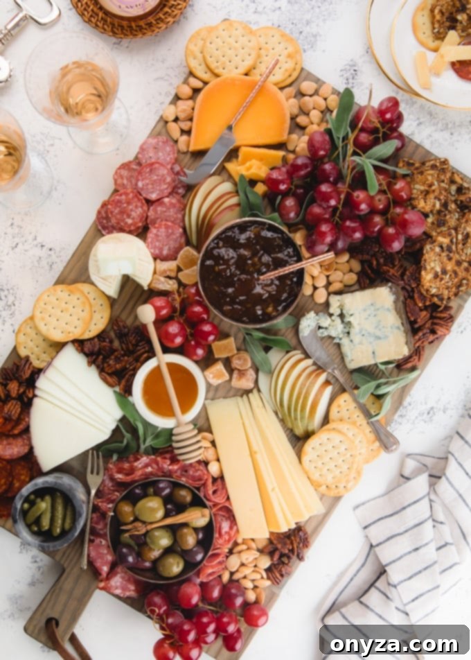Overhead view of a luxurious cheese board filled with an assortment of cheeses, fruits, nuts, and charcuterie, perfect for any gathering.