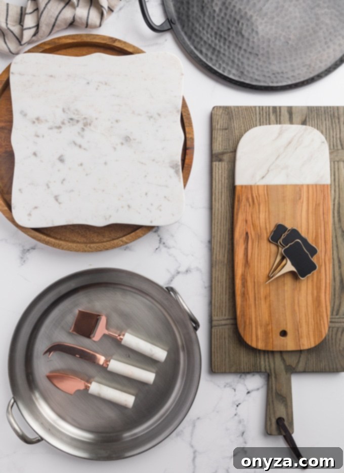 An array of potential cheese board platters and serving tools including various cheese knives and small chalkboard cheese tags, ready for assembly.