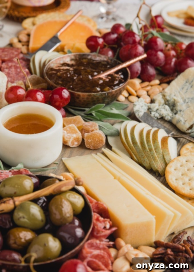 Side view of a bountiful cheese board featuring an assortment of cheeses, cured meats, fresh and dried fruits, nuts, honey, and cornichons, artfully arranged for a feast.
