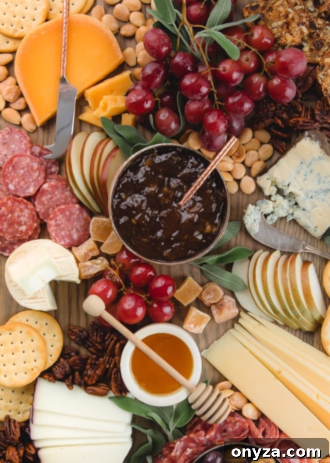 A close-up view of a meticulously arranged cheese and charcuterie plate, highlighting the textures and colors of various foods, ready for serving.