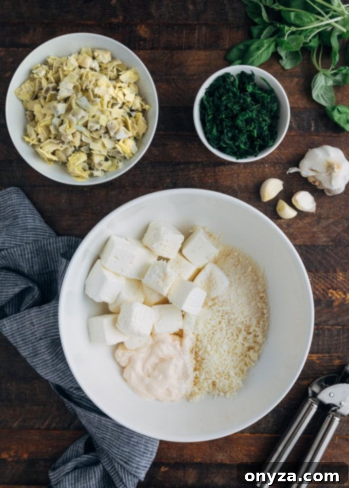 Fresh ingredients for a homemade six-cheese spinach artichoke dip, including cheeses, spinach, and artichoke hearts