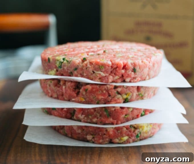 Stacked Mojo Beef Burger Patties Ready for Grilling