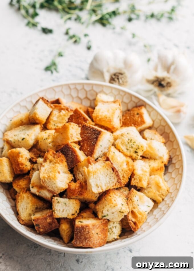 golden brown homemade croutons with garlic butter and herbs in a serving bowl, ready for soup or salad