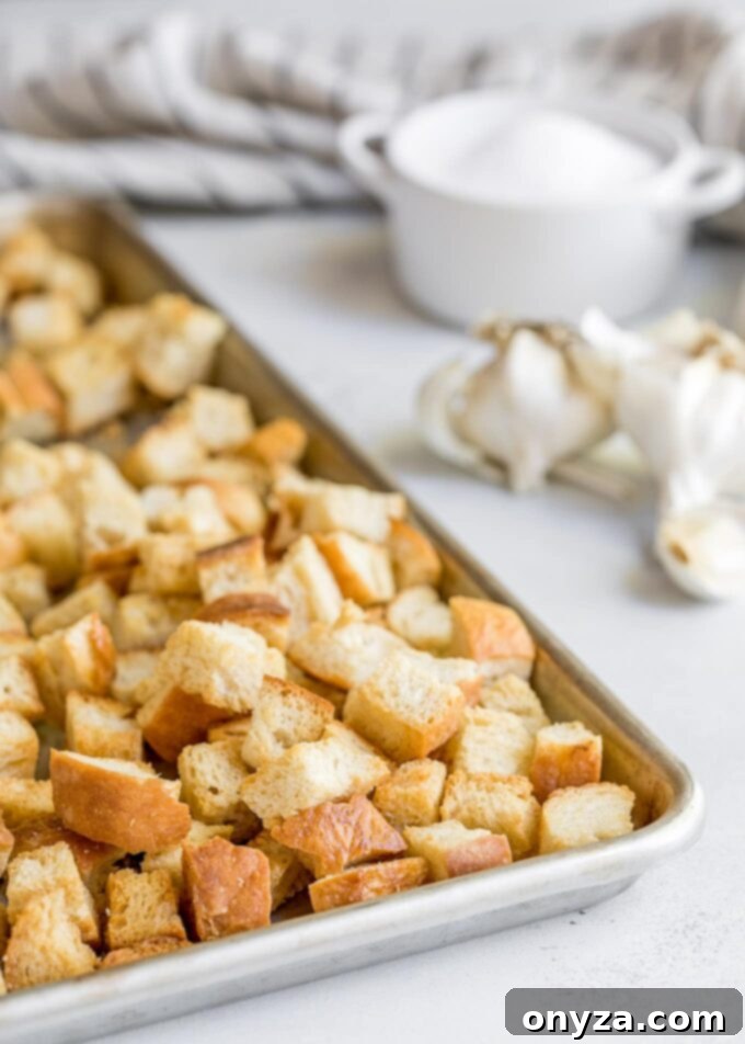 freshly baked homemade croutons cooling on a baking sheet
