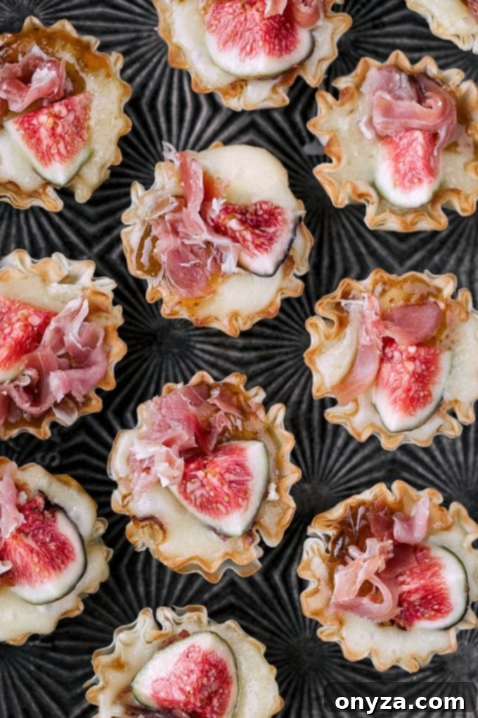 miniature phyllo cups with brie and figs on a serving tray