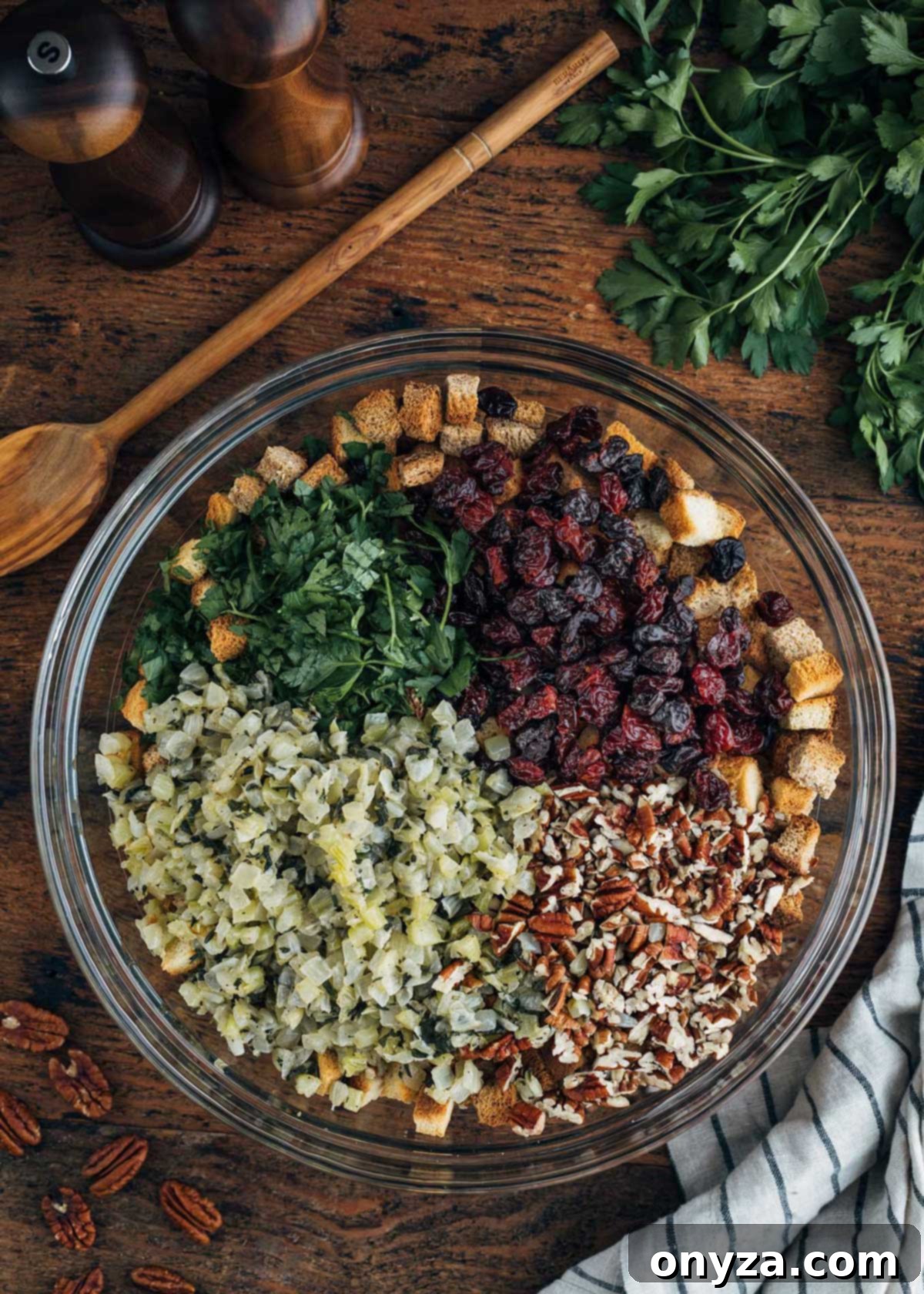 Festive Cranberry Pecan Stuffing 3 dried cranberries, pecans, croutons, and sauteed onions and celery in a large glass bowl