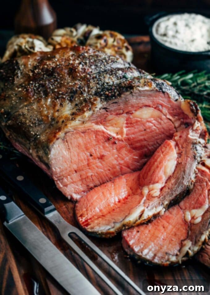 Perfectly sliced slow roasted prime rib on a carving board, showcasing its juicy, rosy interior and crisp crust.