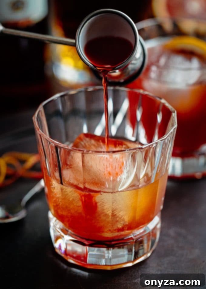Boulevardier Rouge 4 Pouring Campari into a mixing glass for a Blood Orange Boulevardier