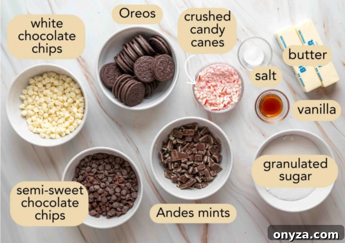 Flat lay of labeled ingredients for Oreo chocolate mint toffee bark, including chocolate chips, Oreos, crushed candy canes, chopped Andes mints, sugar, butter, vanilla, and salt.