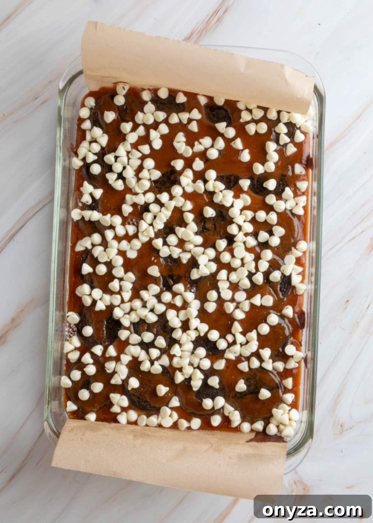Toffee-covered Oreo halves topped with scattered white chocolate chips.