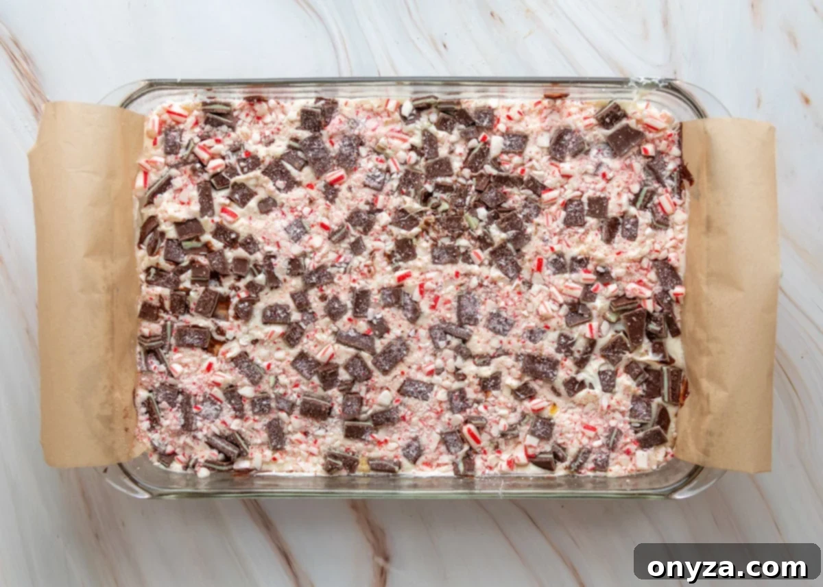 Layered Oreo mint toffee bark generously topped with chopped Andes mints and crushed peppermint candies.