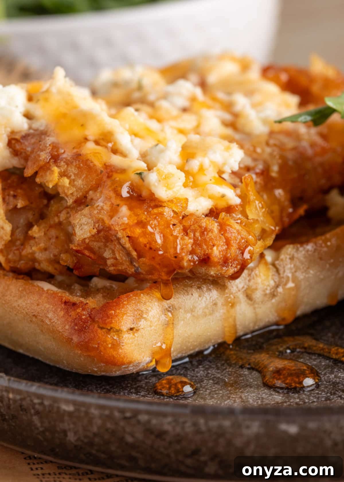 Close-up of crispy chicken topped with Boursin cheese and honey