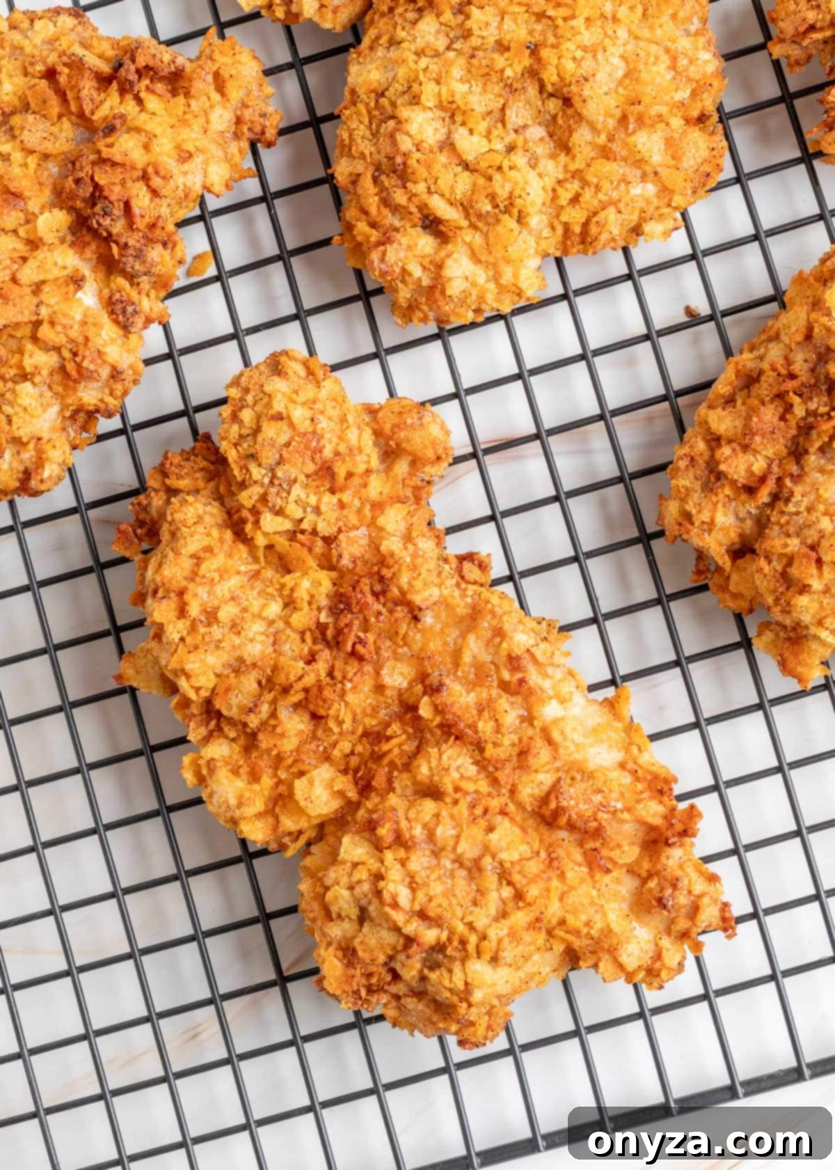 Air fried Potato Chip Chicken cooling on a wire rack.